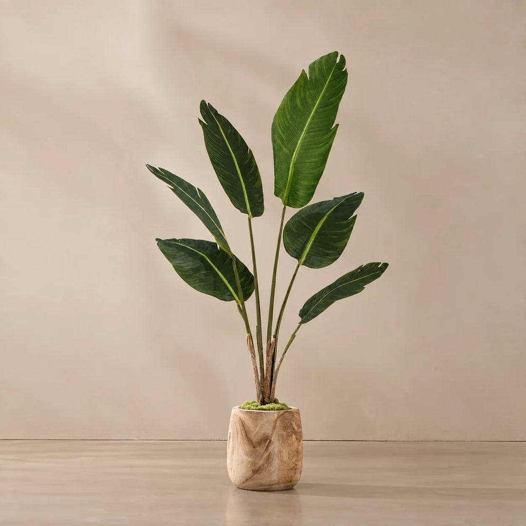 Planta artificial montada en el macetero de madera con musgo decorativo